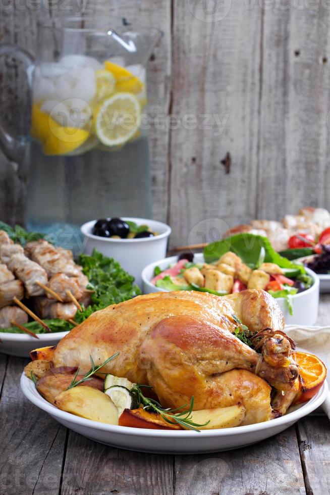 frango inteiro assado na mesa de jantar foto