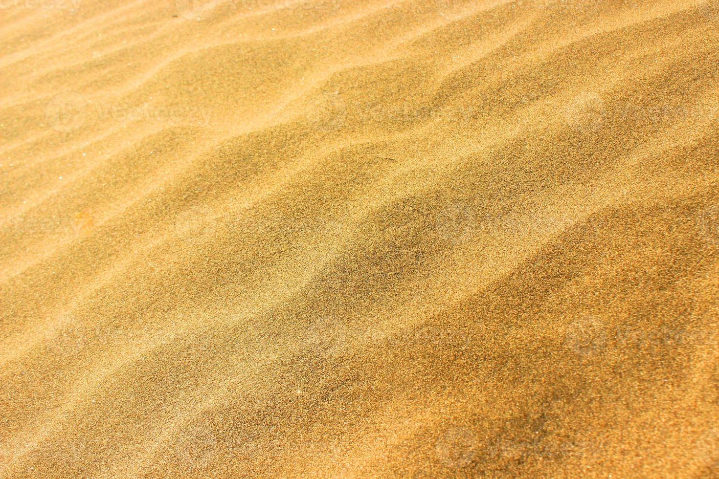 areia de textura na praia como plano de fundo e textura foto