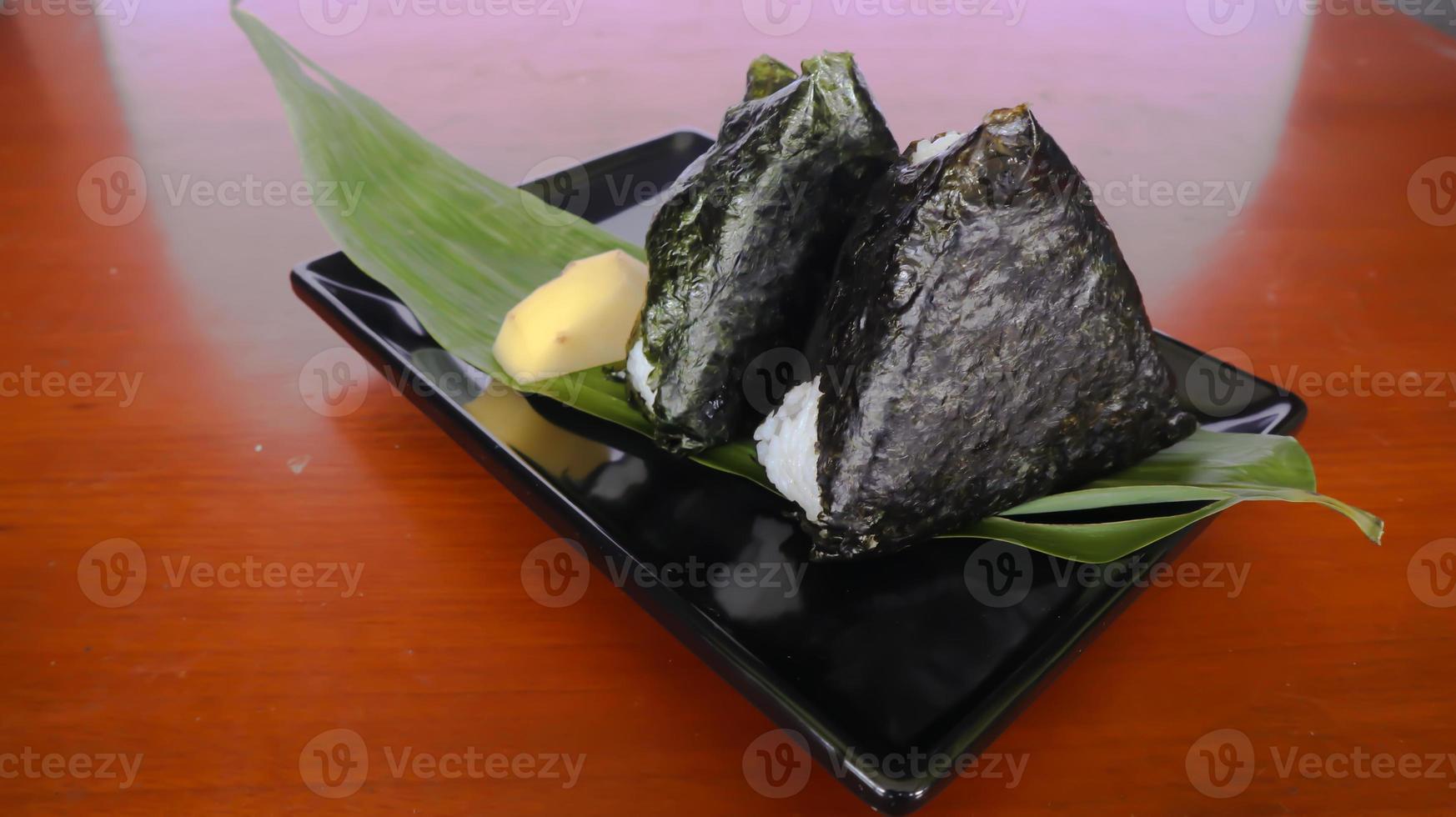 onigiri é comida japonesa, bolinho de arroz japonês, triângulo de arroz com algas marinhas, nori isolado com fundo foto