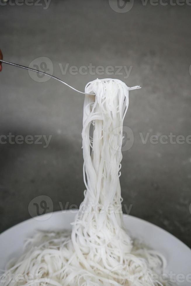 bihun ou aletria ou macarrão de arroz ou cabelo de anjo isolado em fundo preto. servido em tigela pequena foto