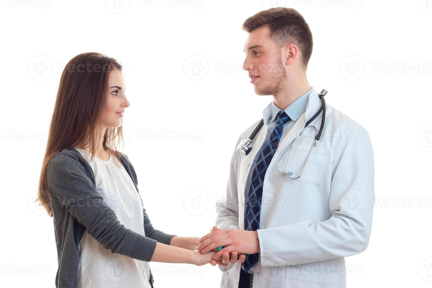 jovem médico segurando a mão de um paciente foto