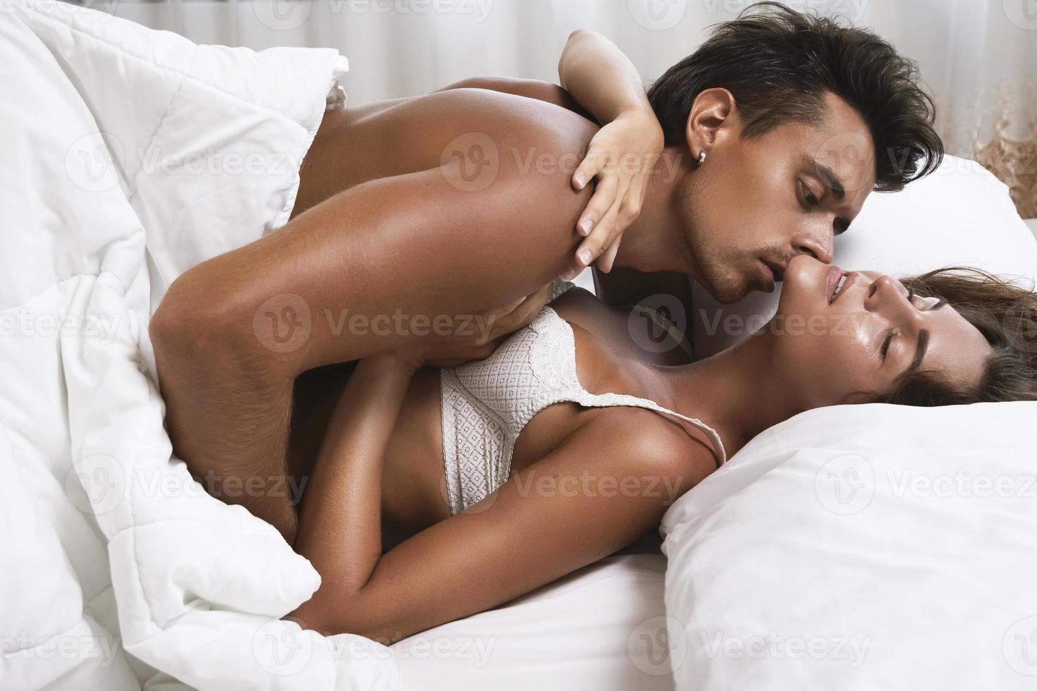 lindo casal abraçado deitado na cama foto