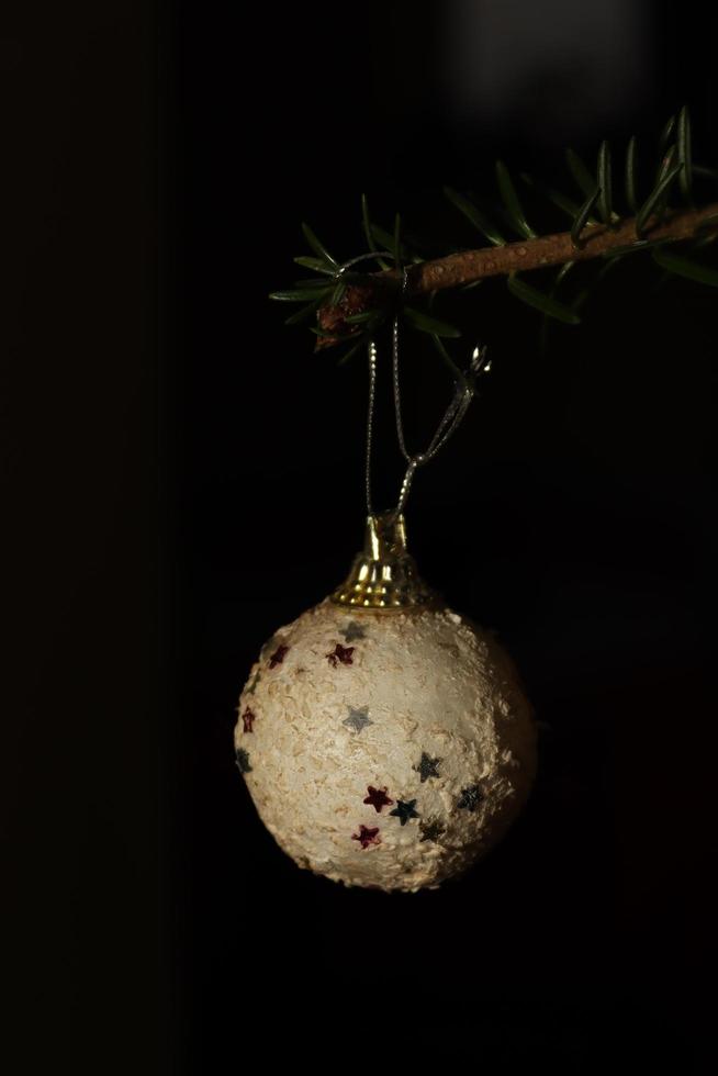 globo de natal branco encontrado em uma árvore natural foto