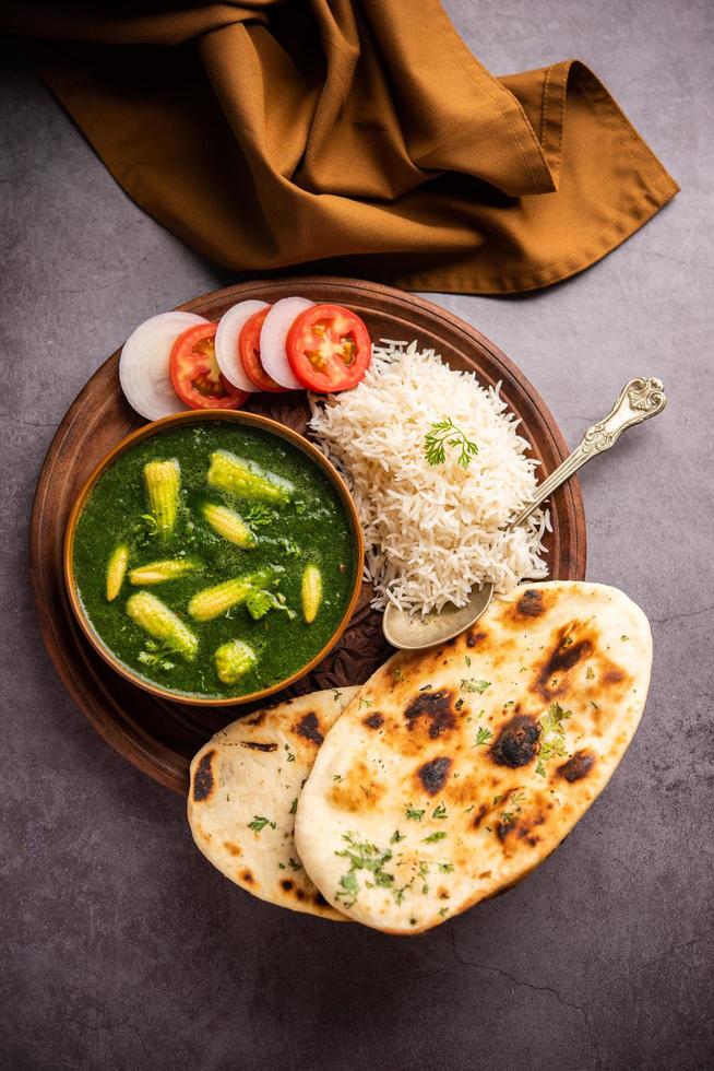 palak baby corn sabzi também conhecido como espinafre makai curry servido com arroz ou roti, comida indiana foto