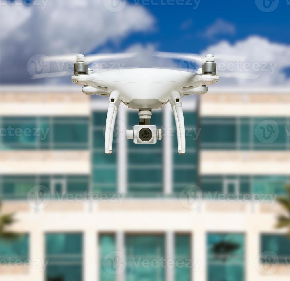 drone quadcopter do sistema de aeronaves não tripuladas no ar perto da cidade e prédio corporativo foto