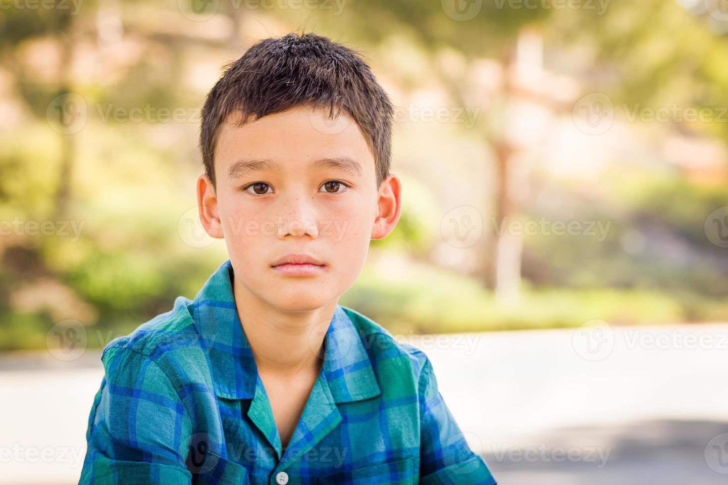 retrato ao ar livre de um menino biracial chinês e caucasiano. foto