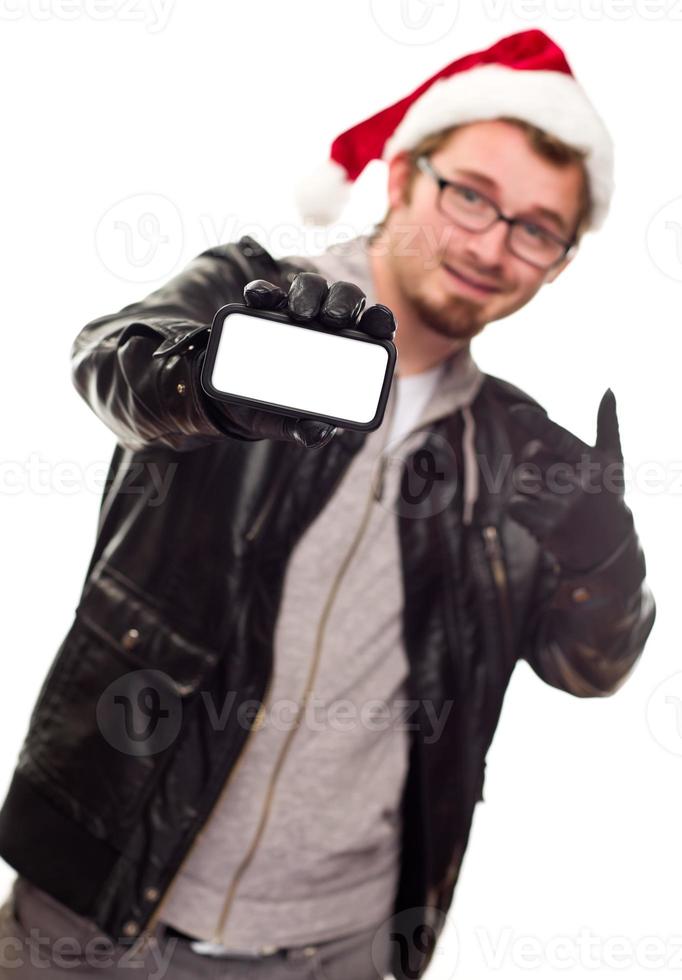 homem com chapéu de papai noel segurando celular em branco foto