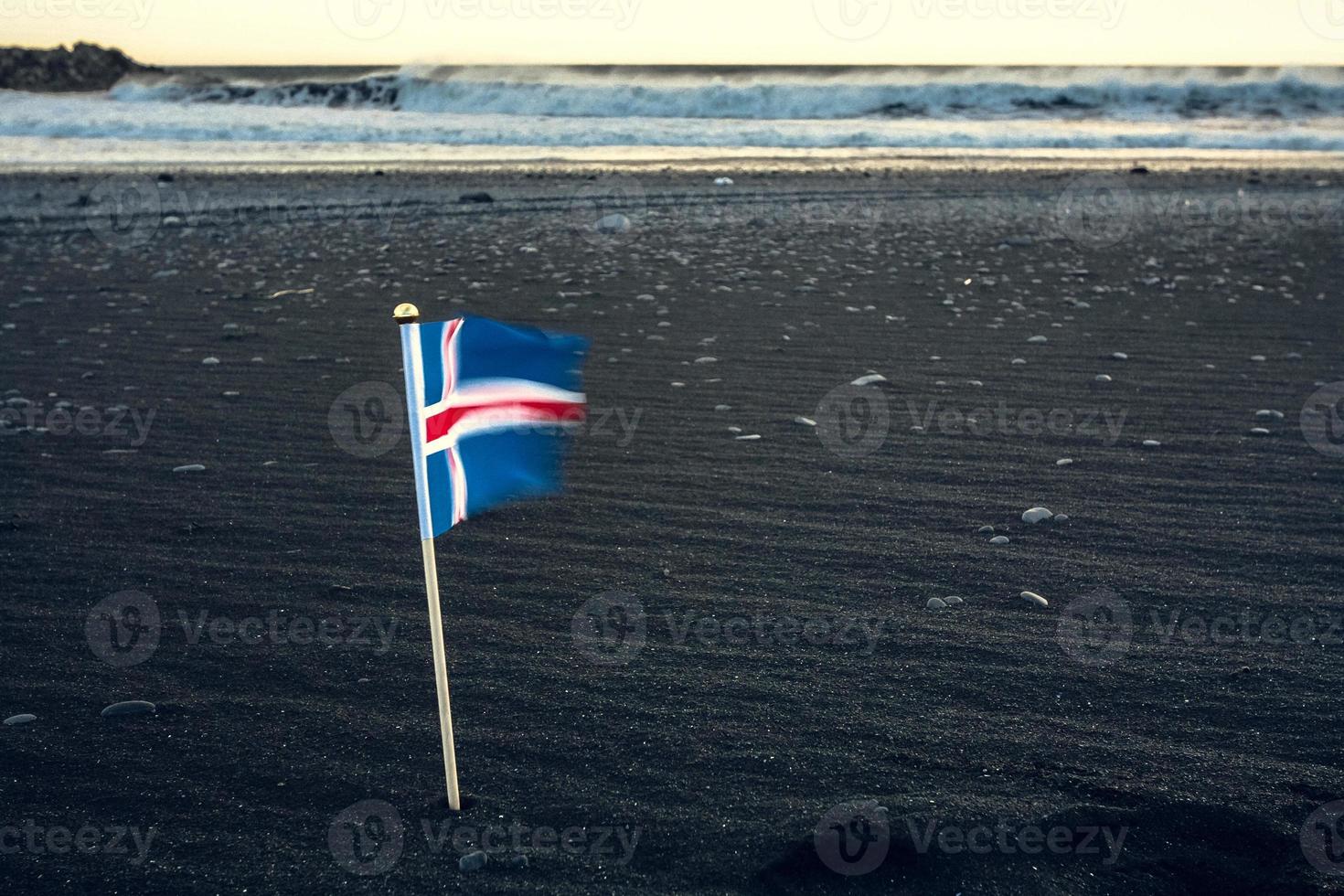 feche a bandeira da islândia na foto do conceito de praia de areia preta