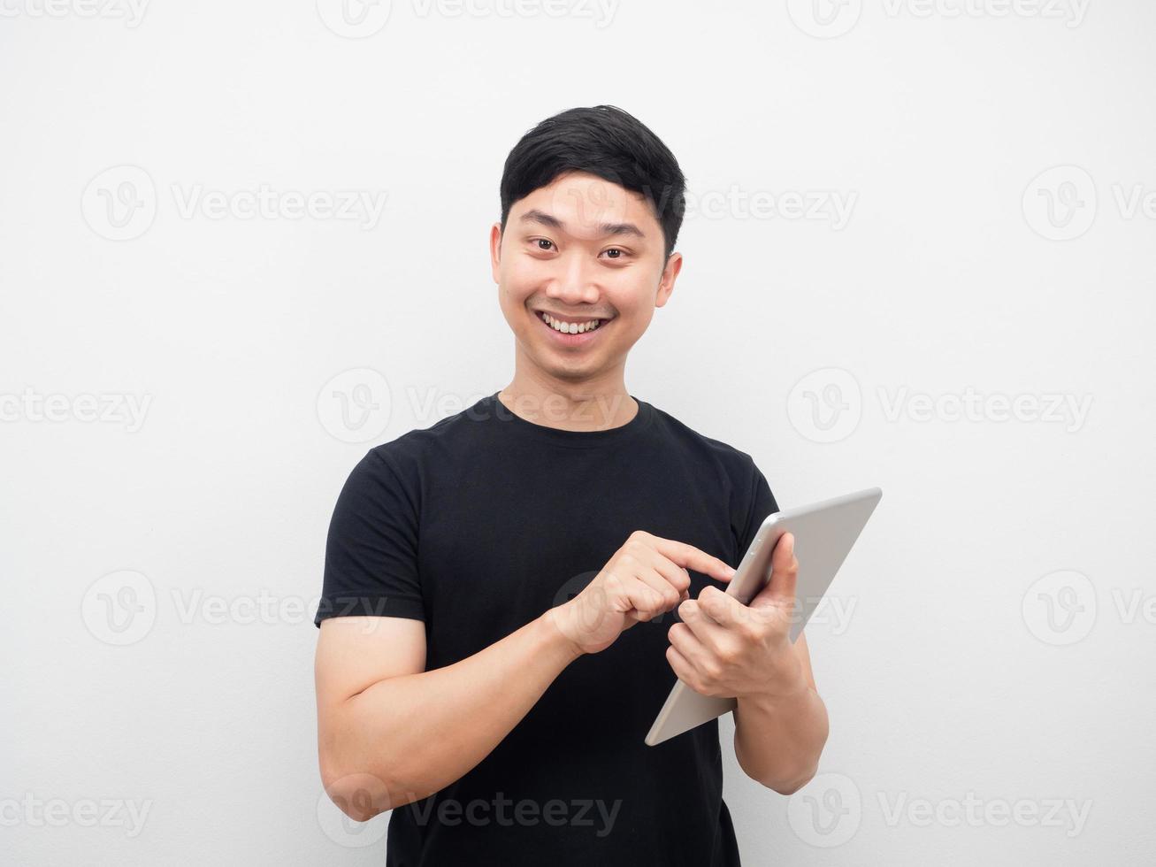 homem asiático sorrindo tela sensível ao toque no ipad na mão foto