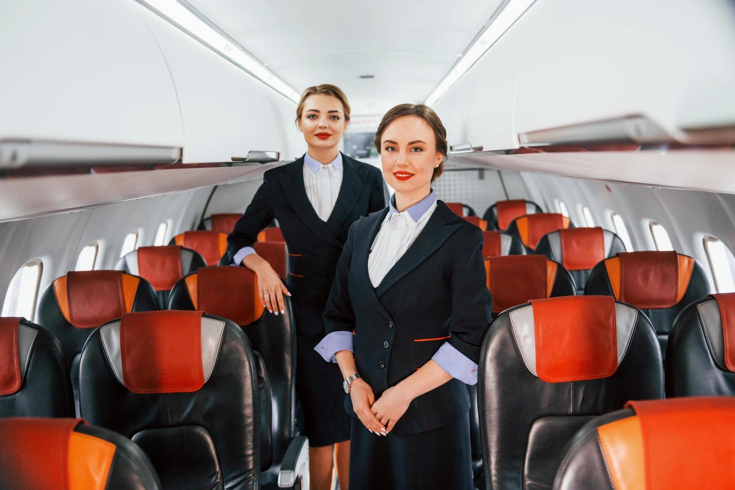 duas aeromoças no trabalho no avião de passageiros foto