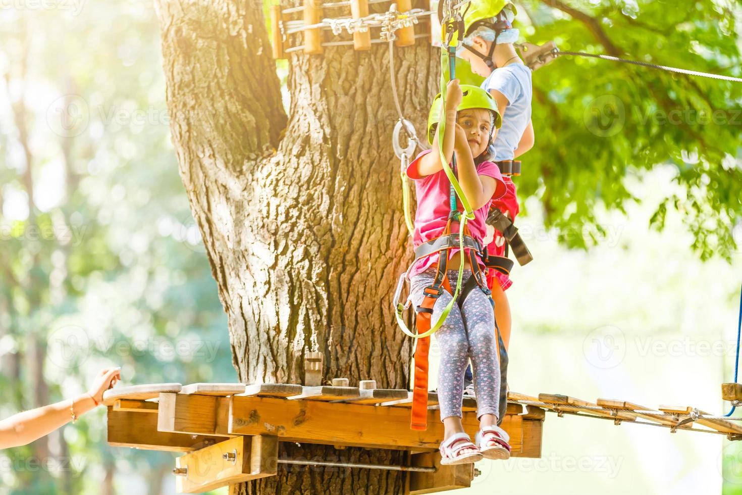 parque de escalada de aventura - parque de corda para crianças no curso de capacete de montanha e equipamento de segurança foto