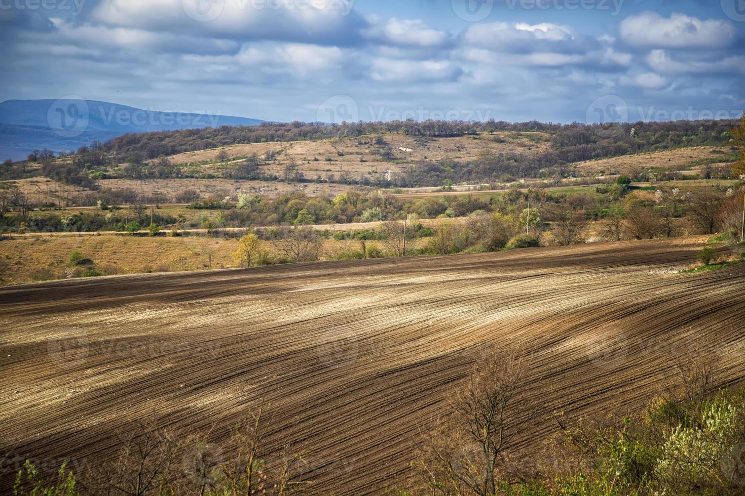 paisagem rural de beleza de um campo arado limpo e pequena aldeia foto