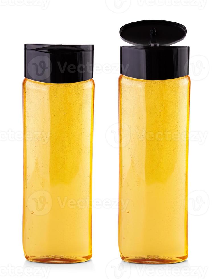 frasco de xampu amarelo sobre um fundo branco foto