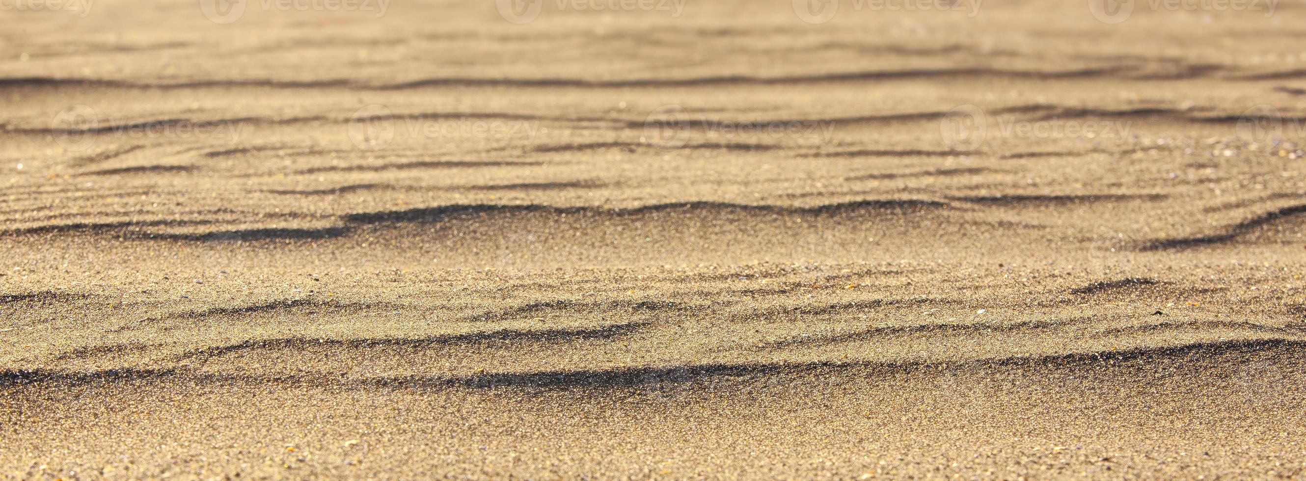 closeup de areia amarela como textura. foco seletivo foto