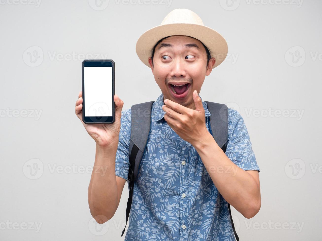 viajante asiático mostra o celular e fica animado com a reserva de férias isoladas foto