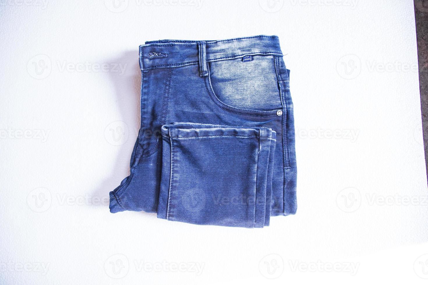 calças jeans dobradas isoladas fundo branco foto