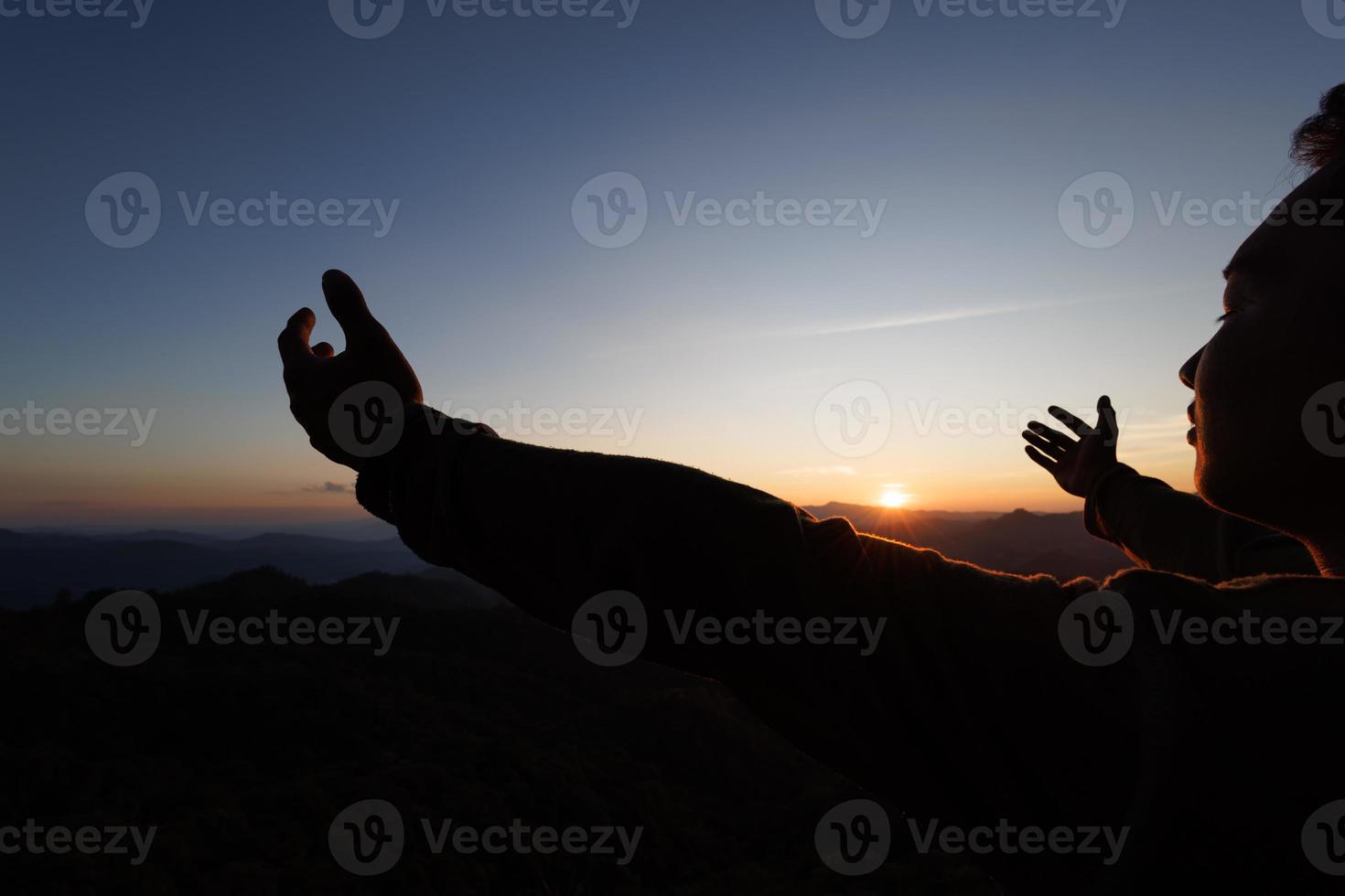 silhueta da mão do homem cristão orando, espiritualidade e religião, homem orando a Deus. conceito de cristianismo. liberdade e aventura de viagem. foto