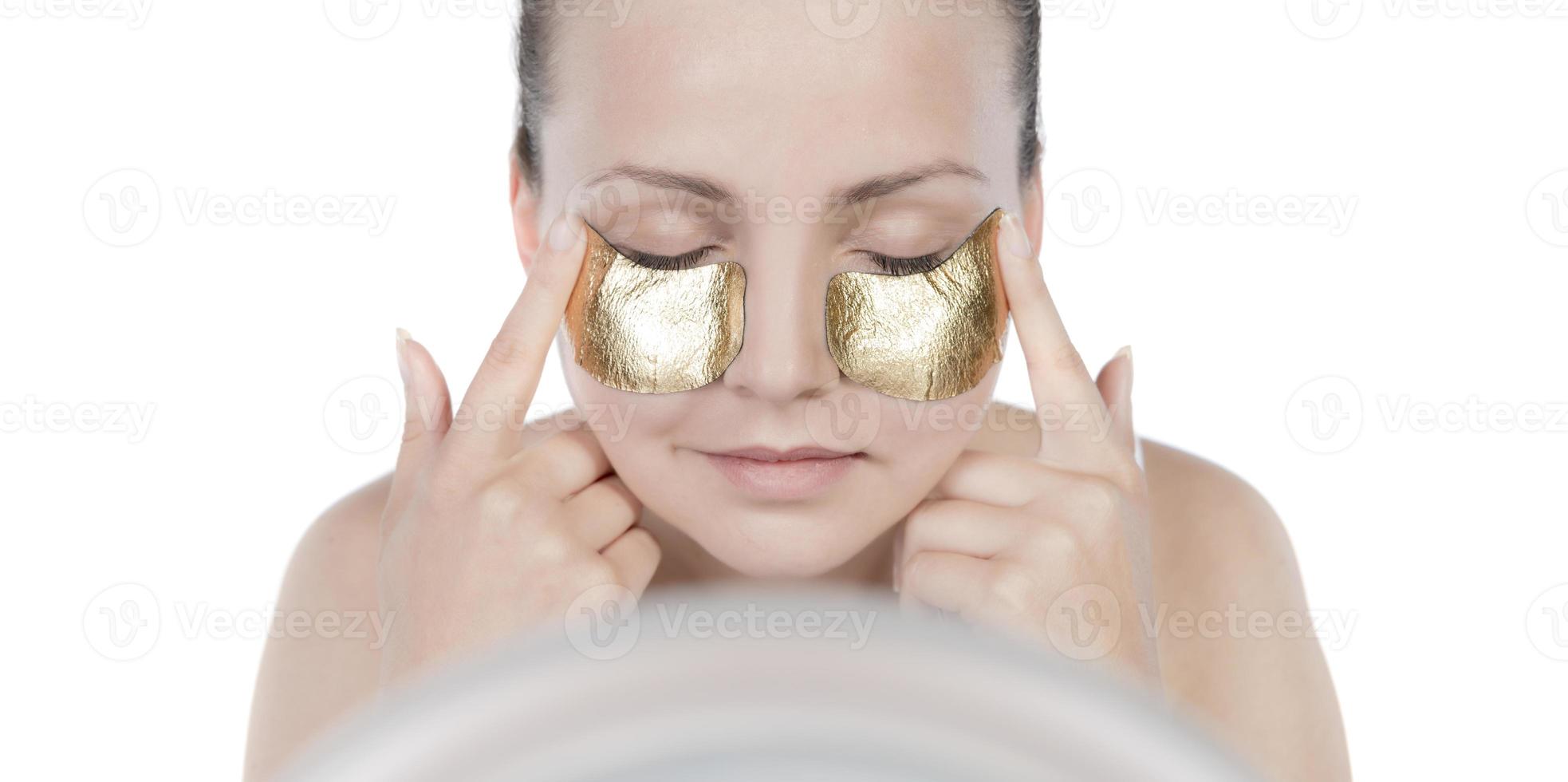 máscara de ouro de mulher, bela modelo com cosmético de pele dourada, cuidados com a pele e tratamento de beleza foto
