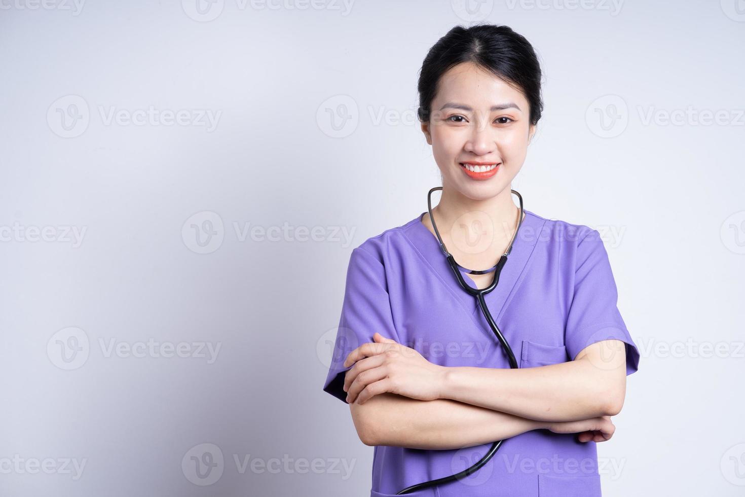 retrato de jovem enfermeira asiática em fundo branco foto