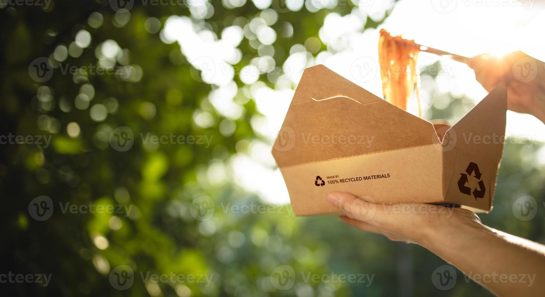 conceito de embalagem reciclada. mulher usando pauzinhos para comer macarrão instantâneo cozido quente de arco reciclado. zero desperdício de materiais. cuidado com o meio ambiente, reutilização, renovável para um estilo de vida sustentável foto