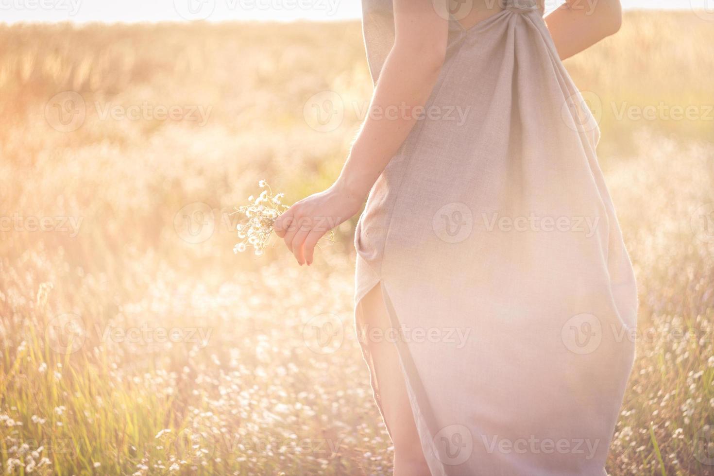 feche a mulher com flores cercadas pela foto do conceito de brilho da luz solar