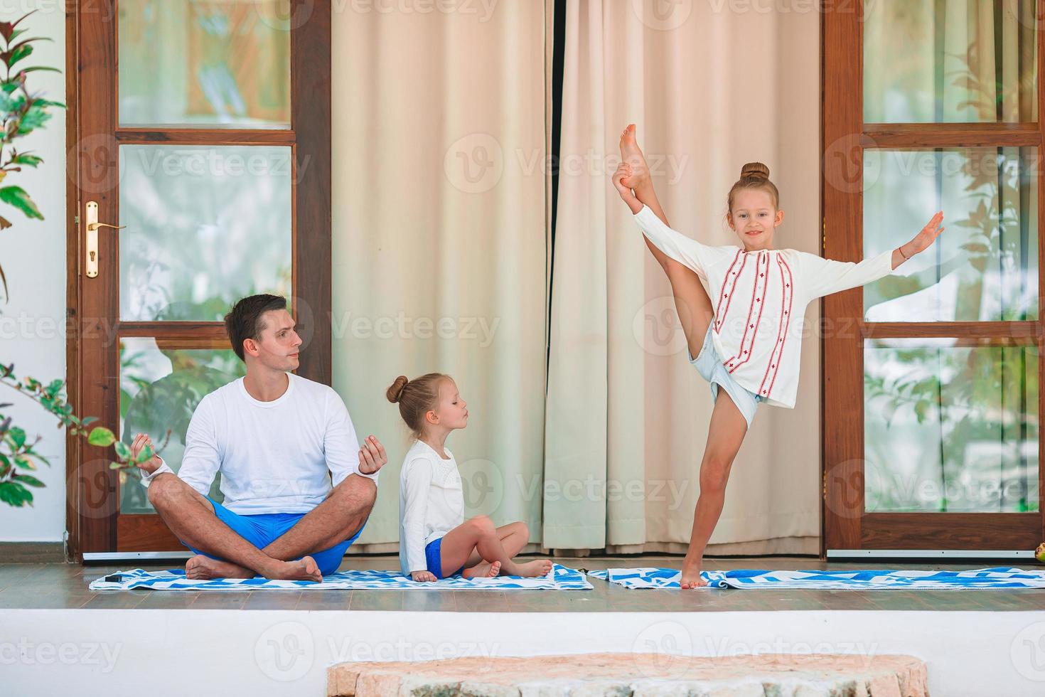 família jovem feliz meditando no terraço foto