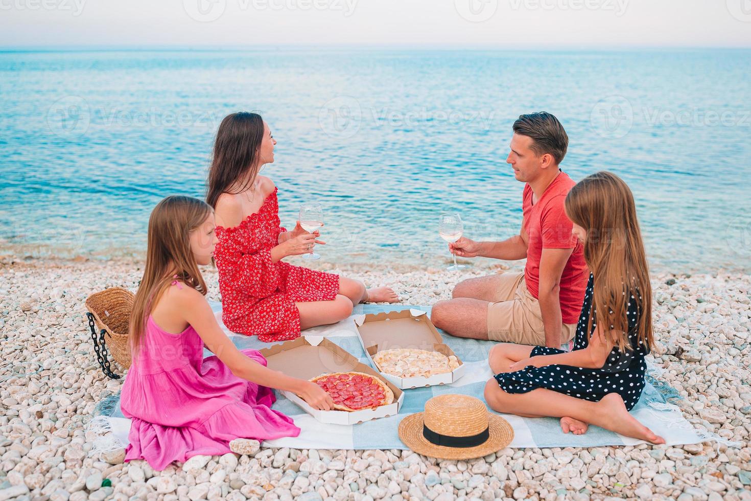 família fazendo um piquenique na praia foto