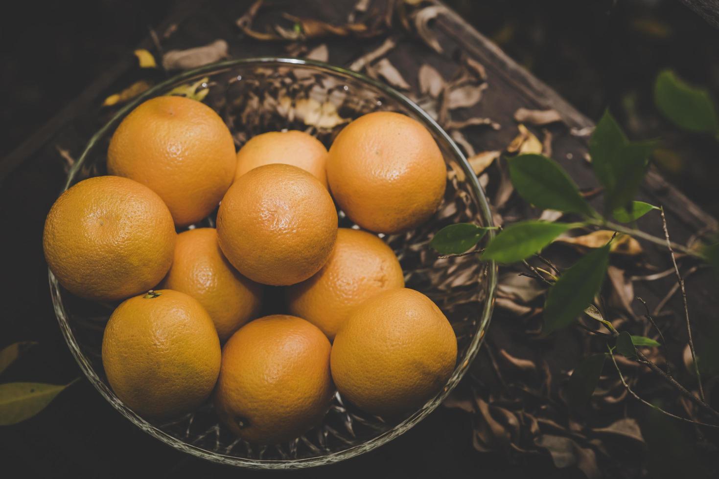 uma cesta de laranjas frescas na natureza foto