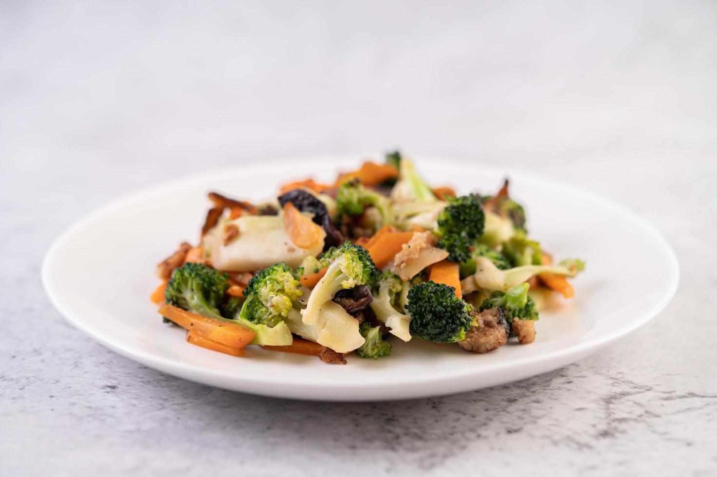 Brócolis, cenoura e cogumelos fritos com carne de porco foto