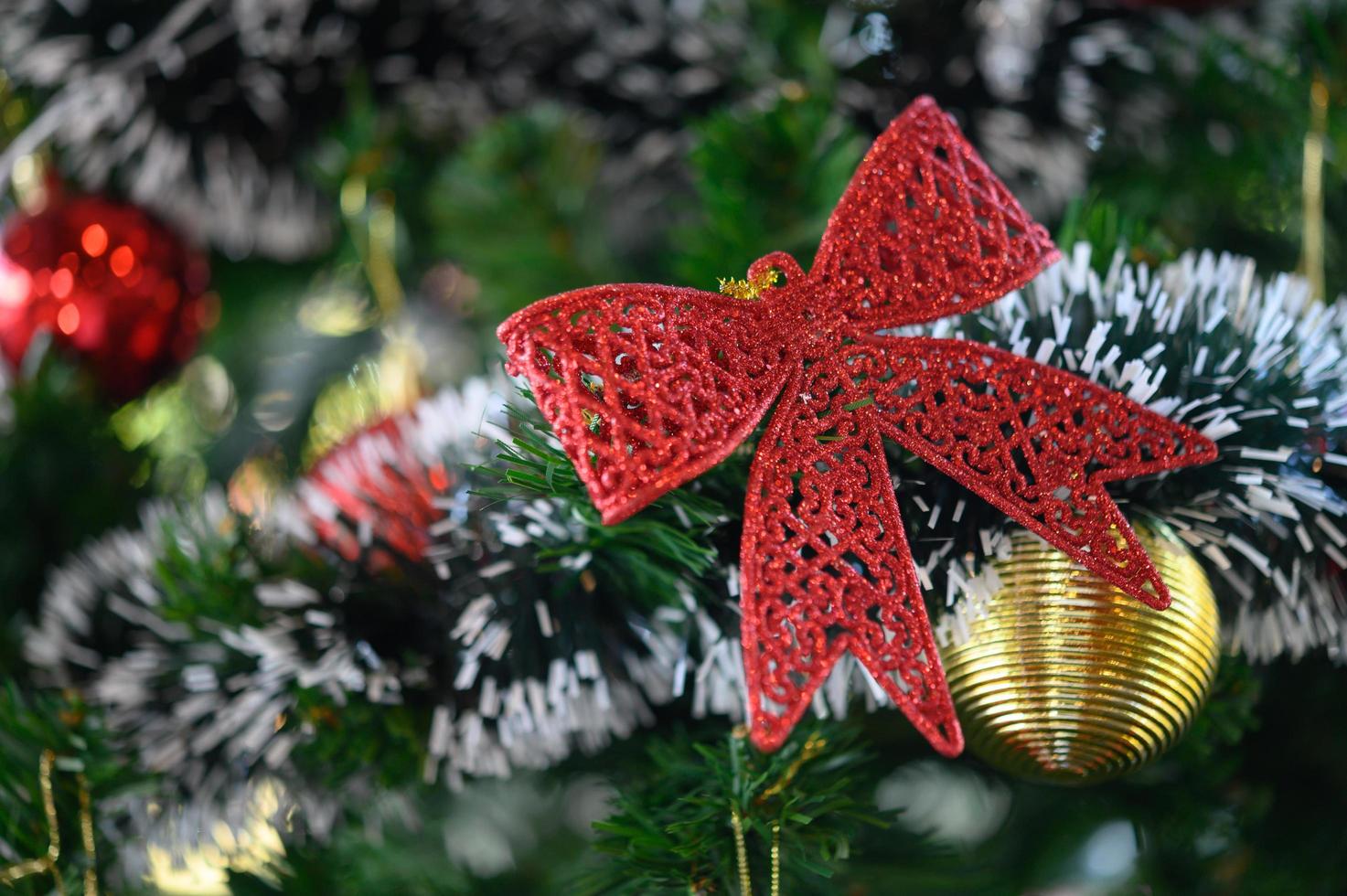 close-up de um laço vermelho em uma árvore de natal foto