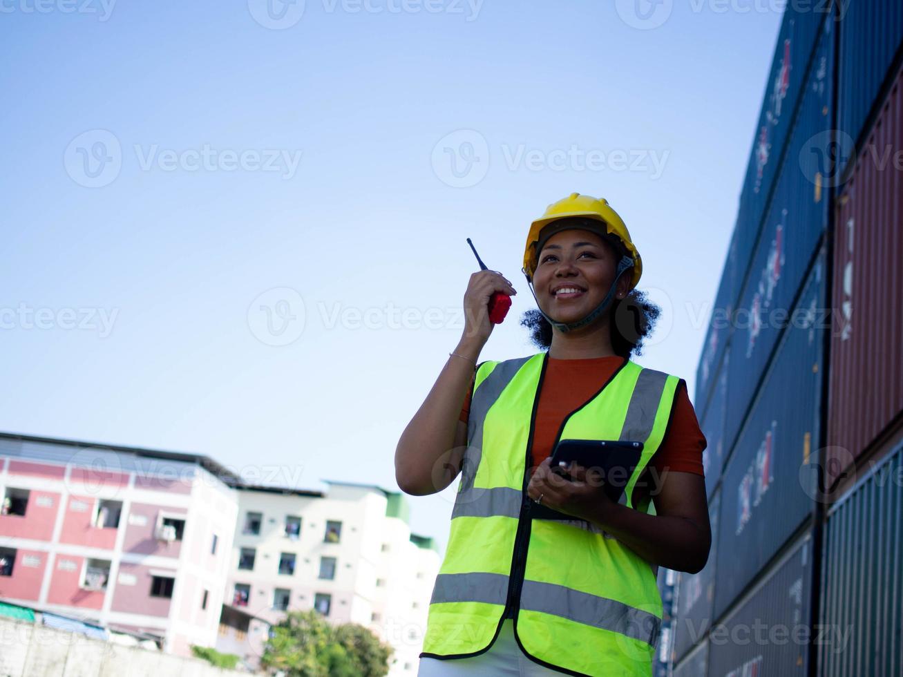 engenheiro trabalho equipe empregado feminino africano preto pele vestir amarelo capacete de segurança capacete segurando talkie walkie rádio tecnologia comunicação trabalhos trabalho contêiner importação exportação local projeto arquiteto foto