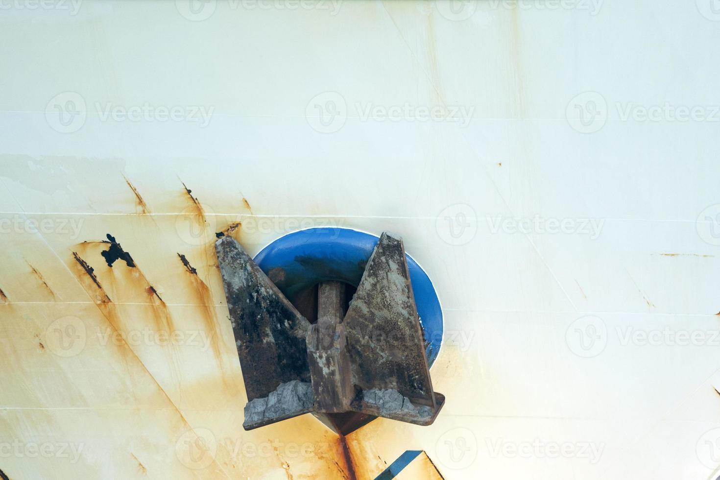 âncora áspera enferrujada no navio de pesca azul foto