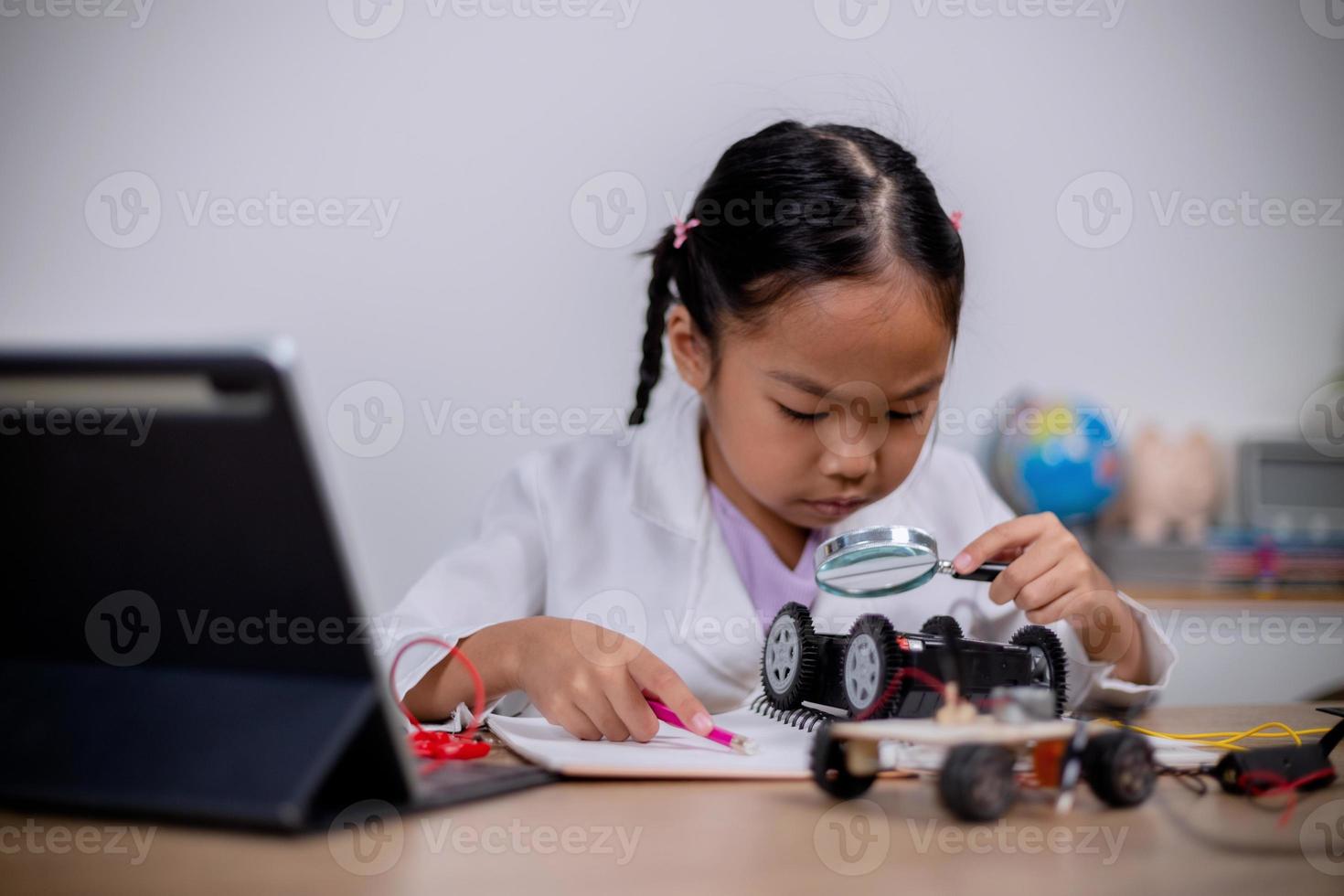 estudantes asiáticos aprendem em casa codificando carros robôs e cabos de placas eletrônicas em haste, vapor, matemática engenharia ciência tecnologia código de computador em robótica para conceitos infantis. foto