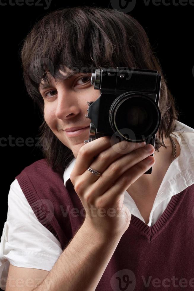 fotógrafo sorridente com a câmera vintage foto