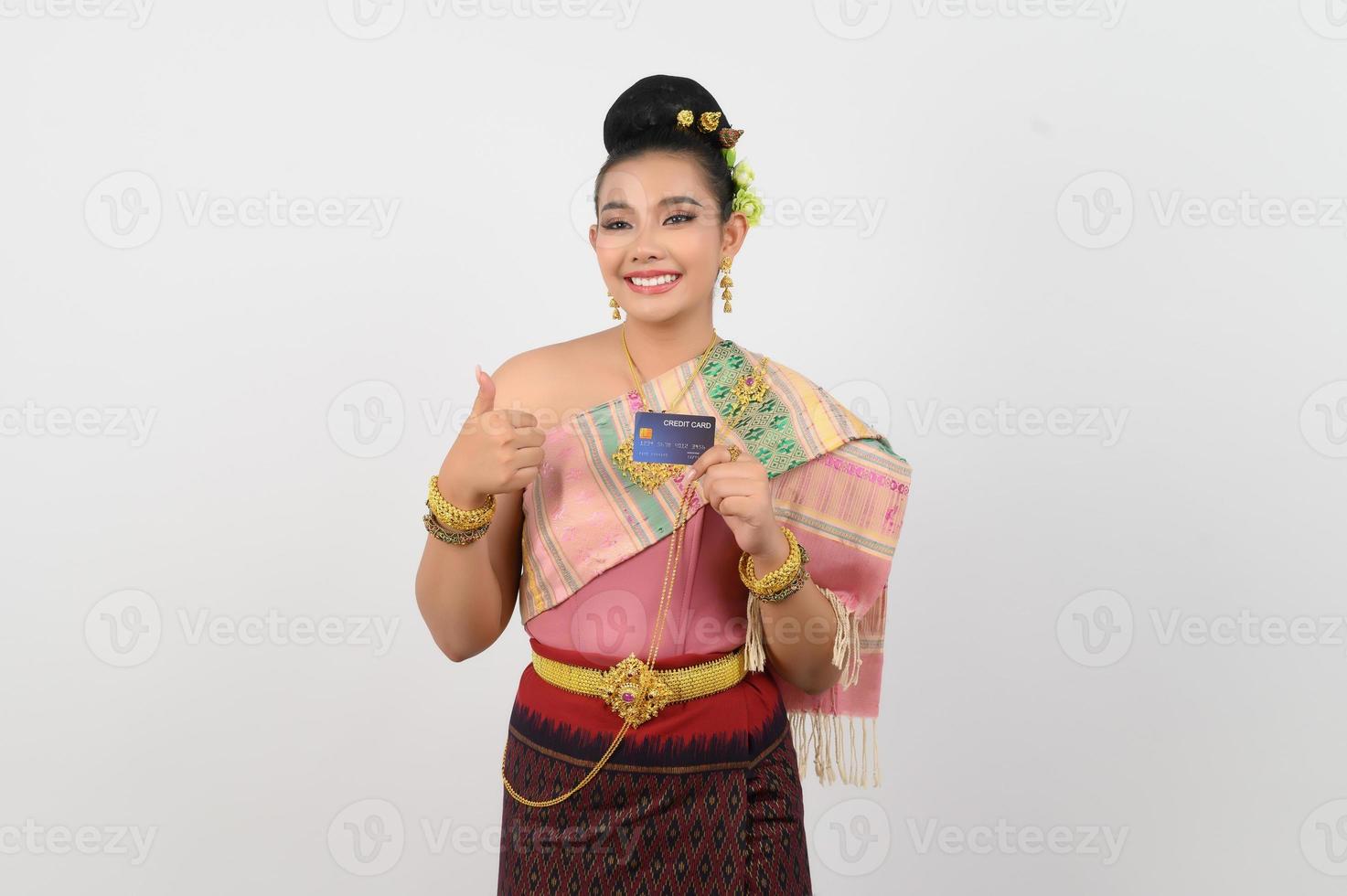 jovem mulher bonita em vestido nordestino mostra postura de cartão de crédito foto