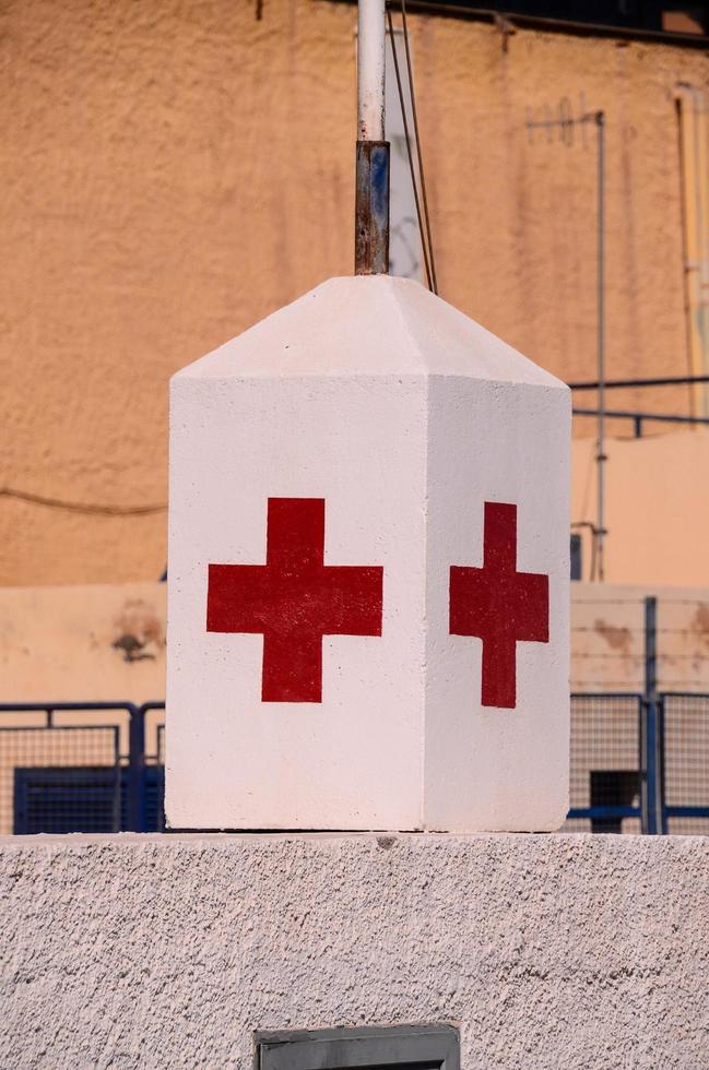 cruz vermelha em um bloco de concreto foto
