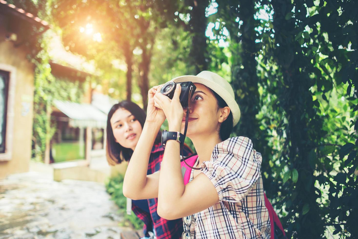 duas mulheres se divertindo enquanto estão sentadas no banco foto