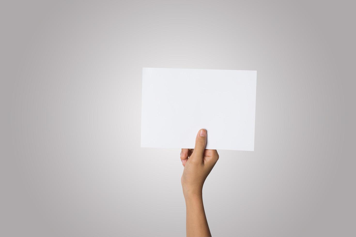 close-up da mão de uma mulher segurando um papel em branco, isolado no fundo branco foto