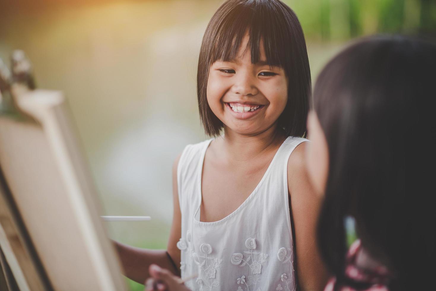 duas meninas pintoras desenhando arte no parque foto