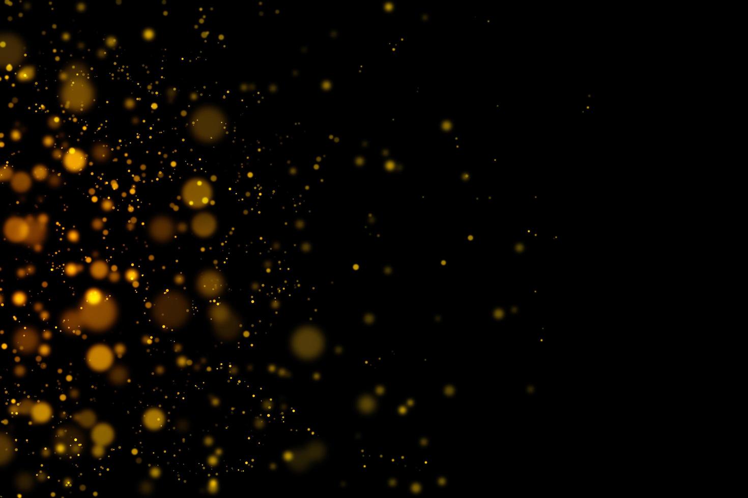 círculos dourados borrados em fundo preto foto