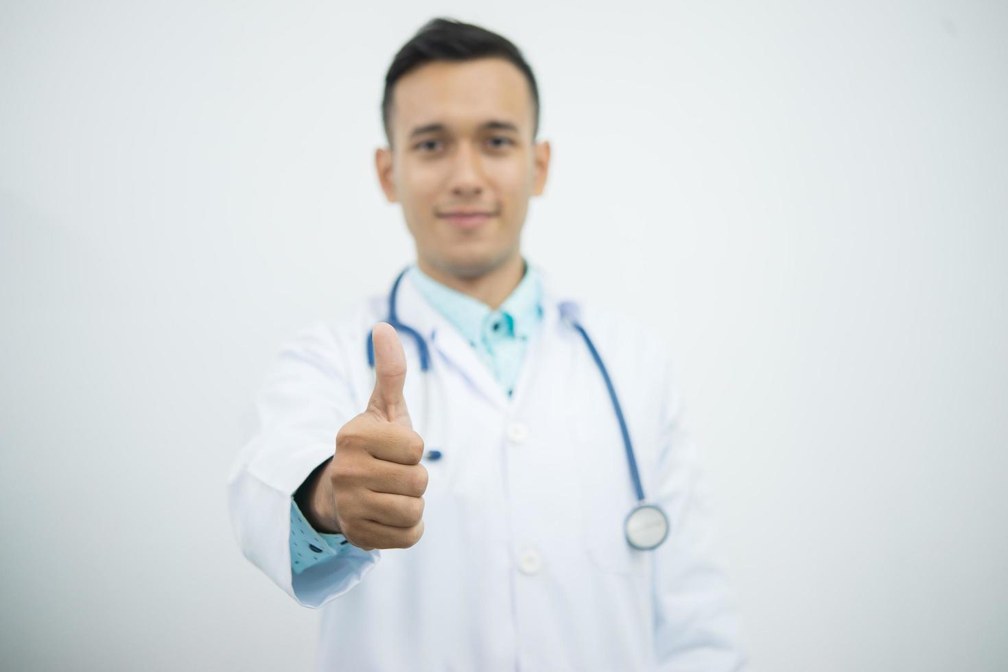 médico com estetoscópio fazendo sinal de positivo foto