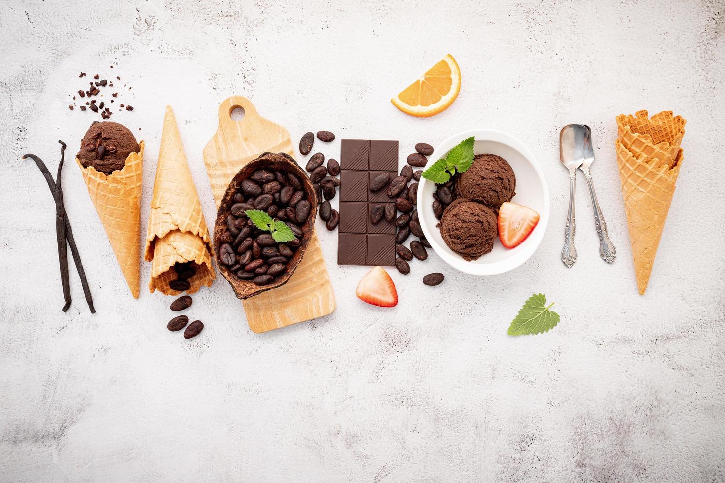 sabores de sorvete de chocolate em tigela com chocolate amargo e nibs de cacau foto