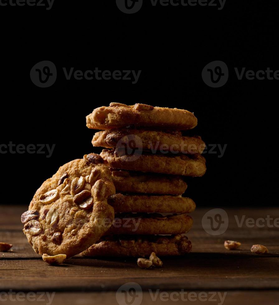 pilha do cozido volta biscoitos em uma de madeira mesa, Preto fundo foto