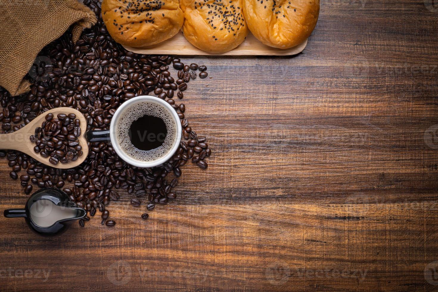 grãos de café com pão fresco foto