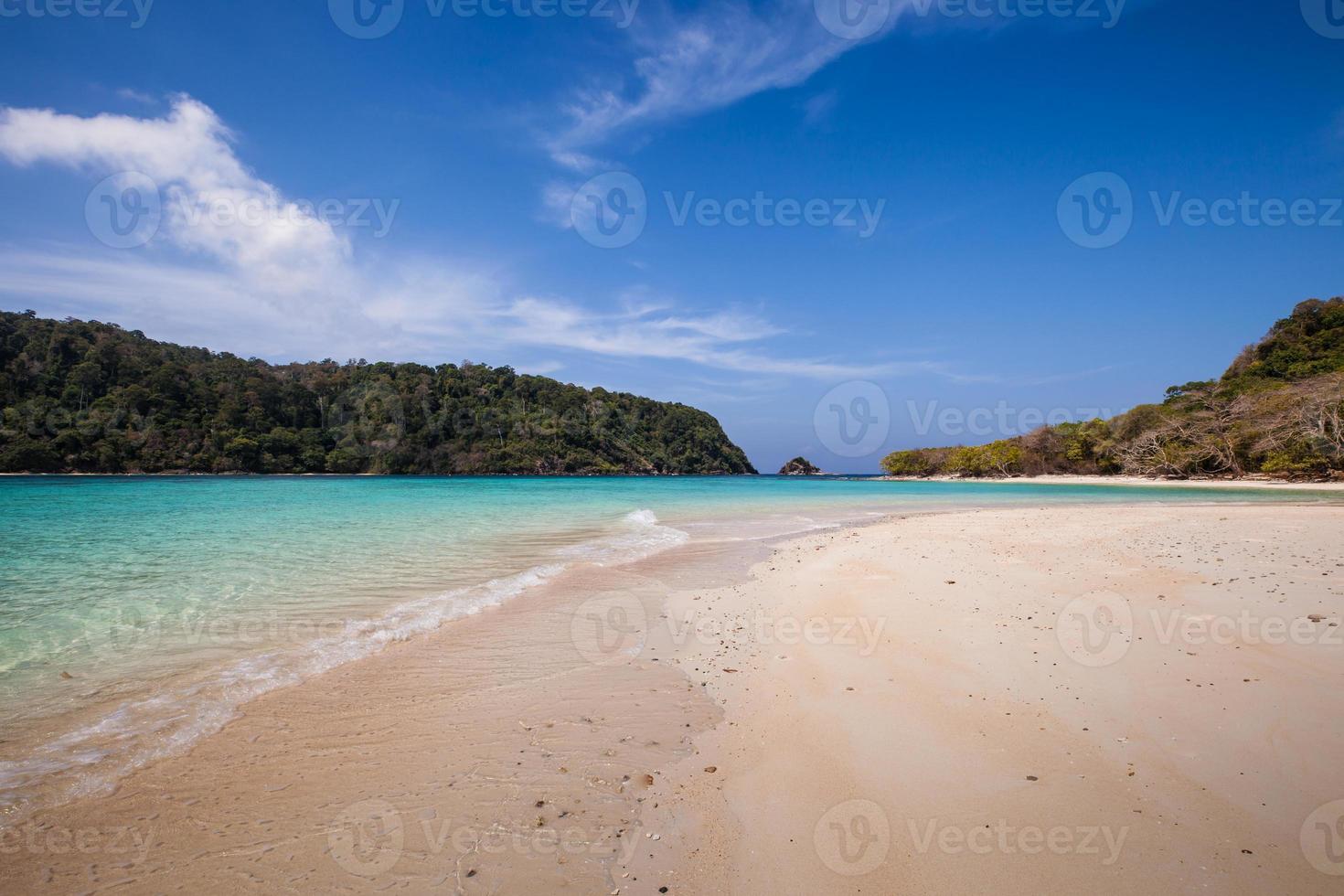 praia de areia branca e água azul foto