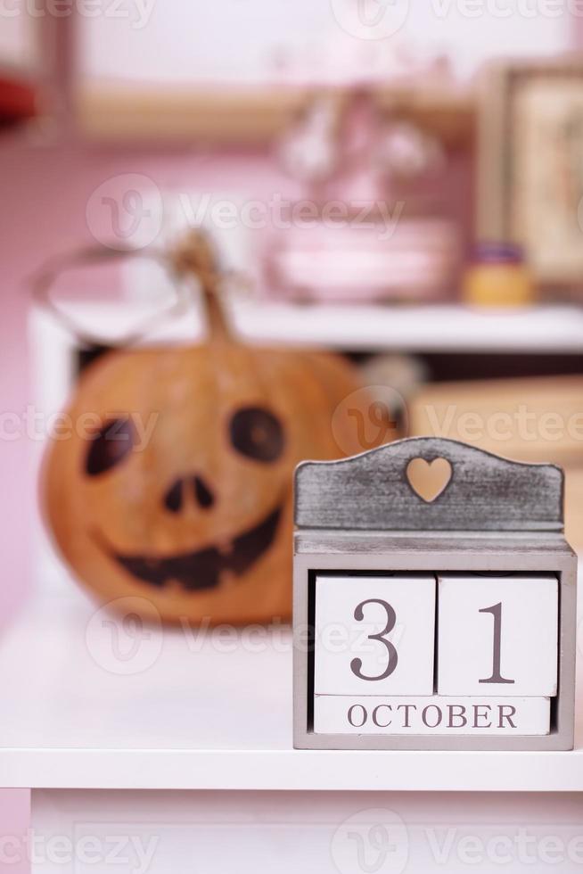 dia das Bruxas feriado fundo com abóbora e calendário com 31 Outubro em de madeira mesa dentro alunas sala. foto
