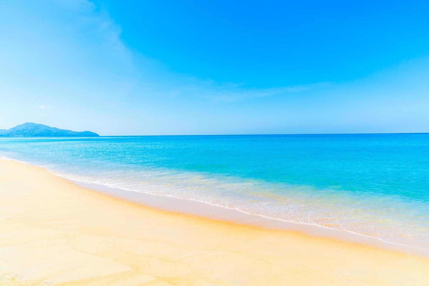 bela praia de areia e mar foto