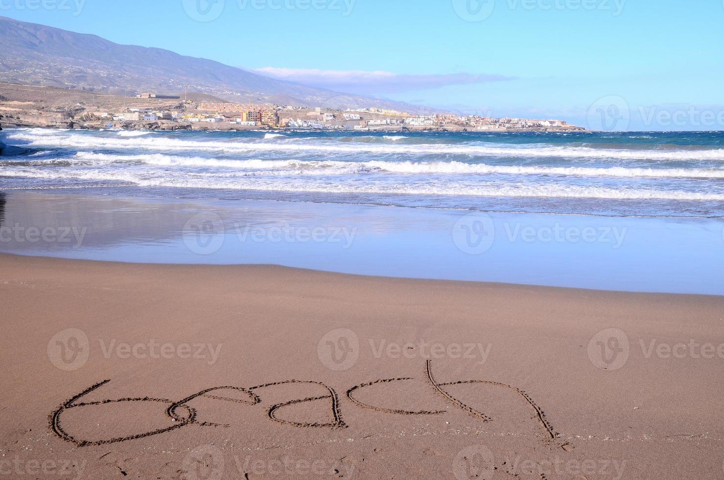 escrevendo dentro a areia foto
