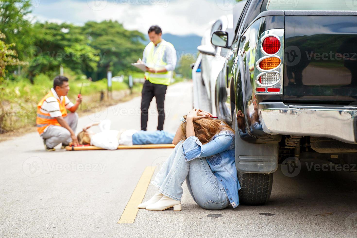 uma jovem mulher senta chorando Próximo para a carro ela caiu para dentro alguém em a estrada. foto