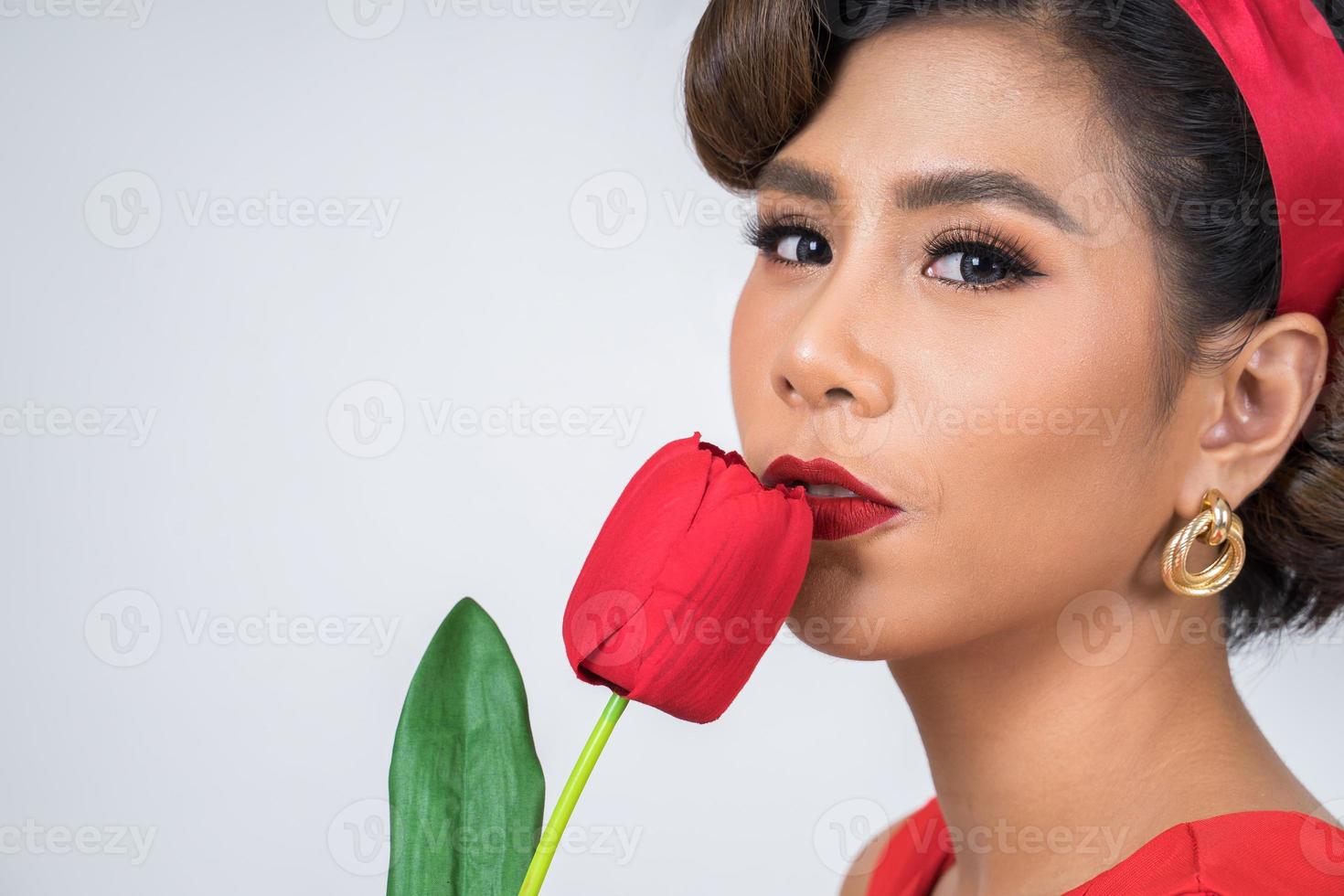 retrato de uma linda mulher com flores de tulipa vermelha foto